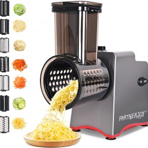 7-in-1 electric cheese grater with various stainless steel cones and sliced vegetables on a kitchen counter.